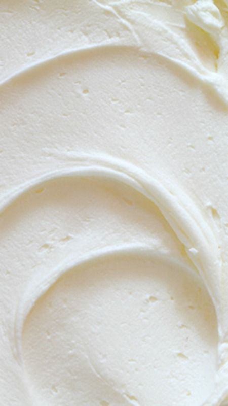 a close up view of white frosting on a cake