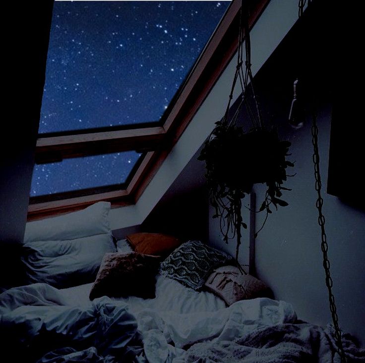 an unmade bed under a sky filled with stars