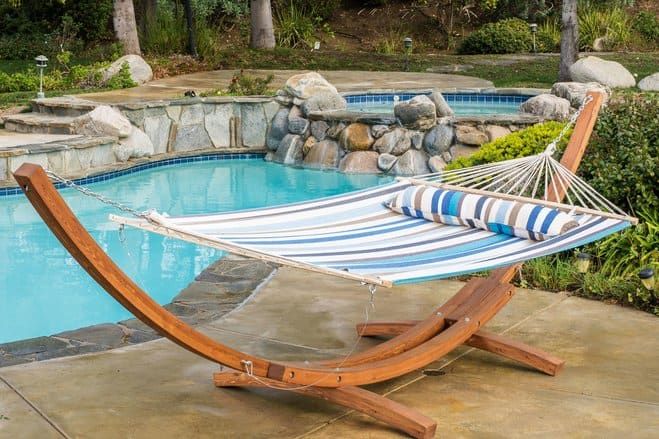 a hammock sitting next to a swimming pool