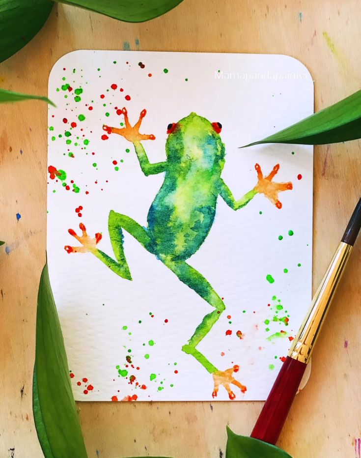 a frog is painted on a piece of paper