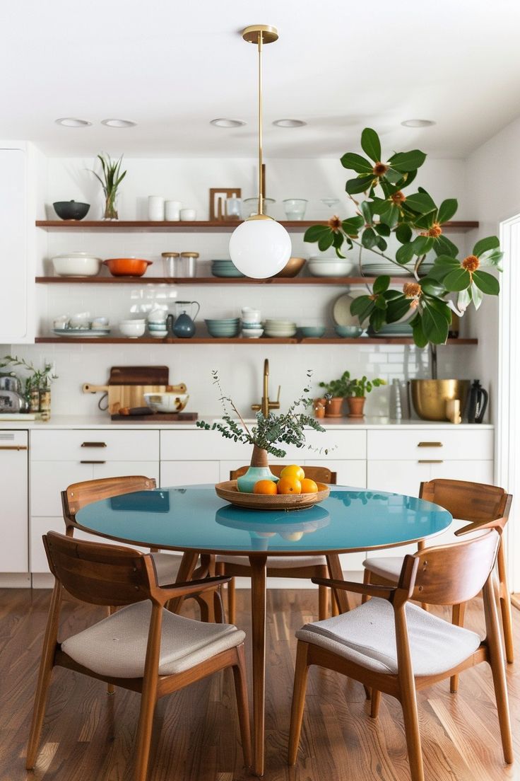 a dining room table with chairs around it and shelves above the table filled with dishes