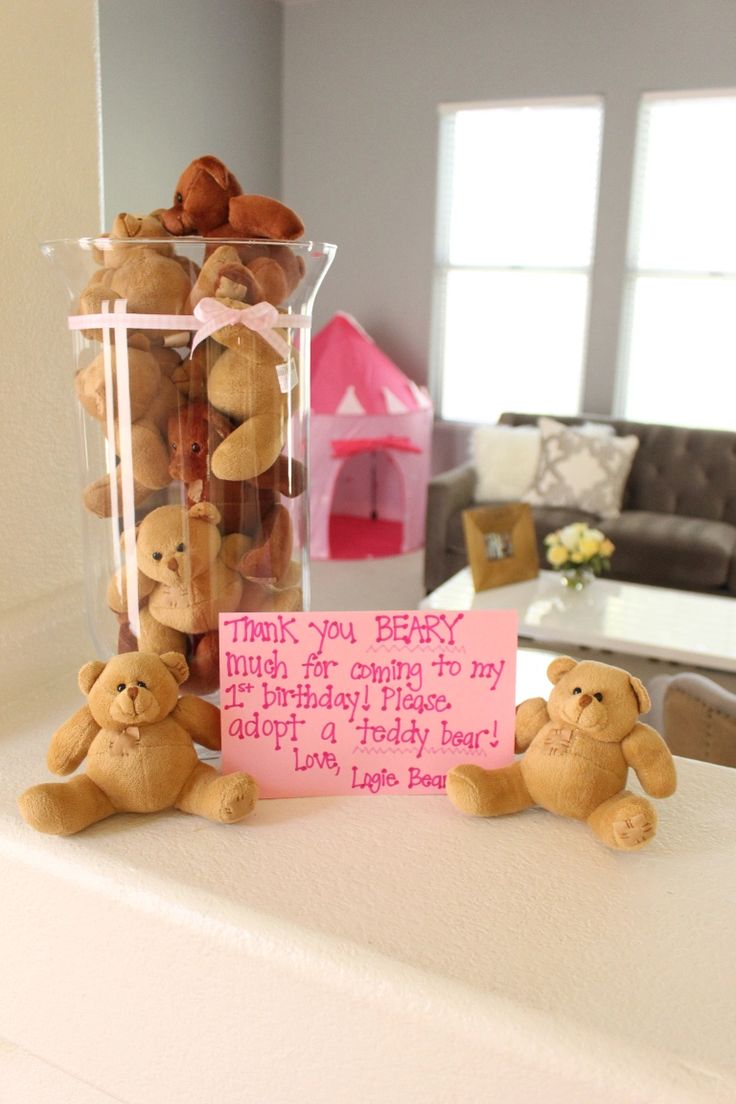 teddy bears sitting on top of a table next to a sign that says thank you baby