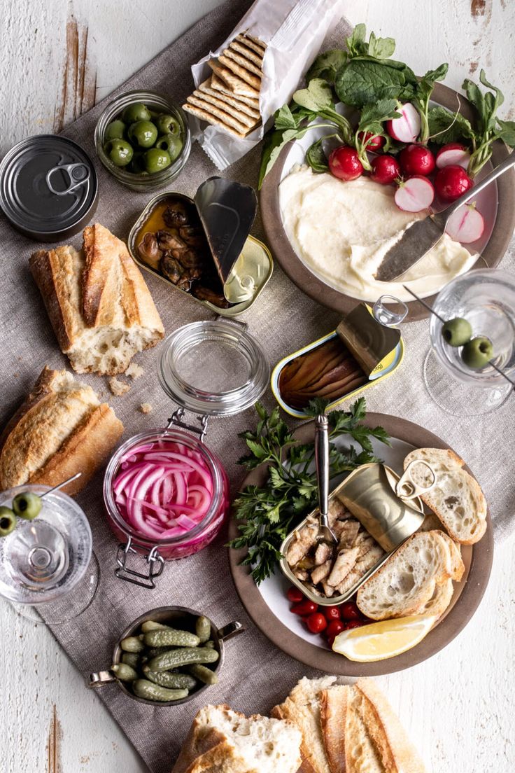 a table topped with plates and bowls filled with food