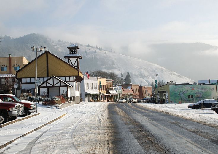 a small town is covered in snow on a cloudy day