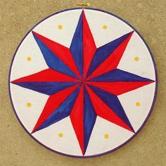 a red, white and blue star is on the floor in front of a wall