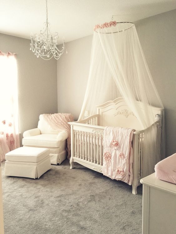 a baby's room is decorated in pink and white