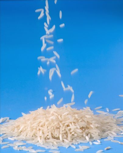 rice falling into the air on a blue background