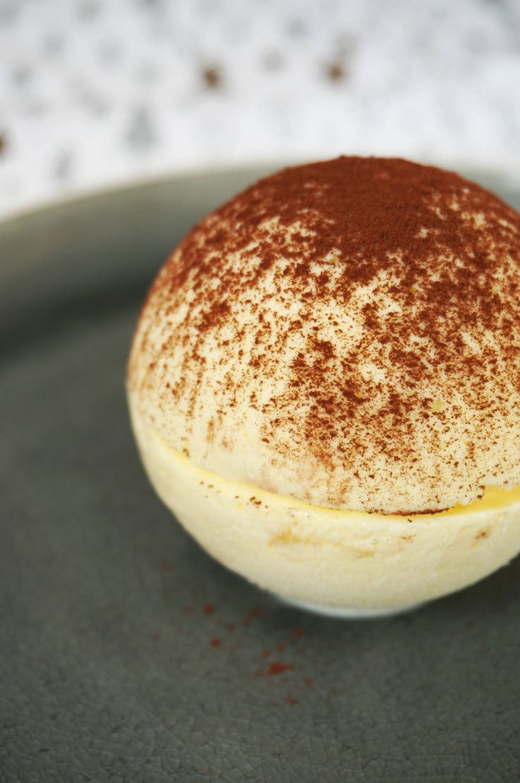 a close up of a dessert on a plate with powdered sugar and cinnamon sprinkles