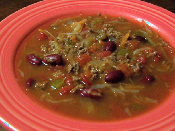 a red bowl filled with soup and beans