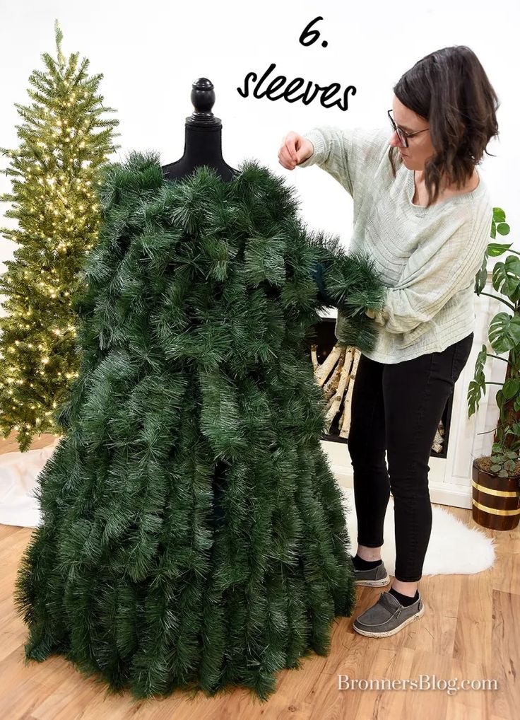 a woman standing next to a mannequin made out of fake pine cones with text overlay