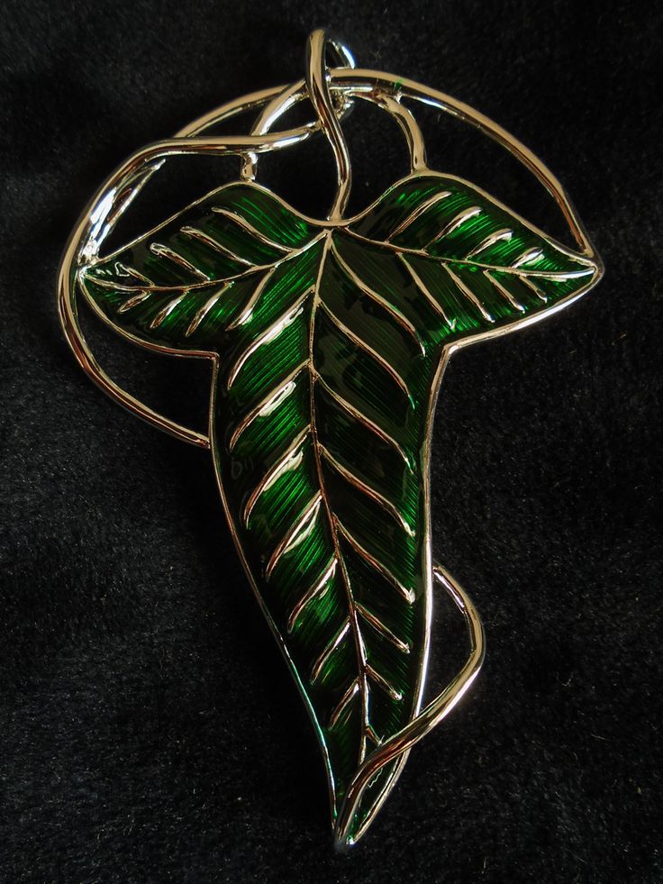 a green leaf shaped pendant on a black background