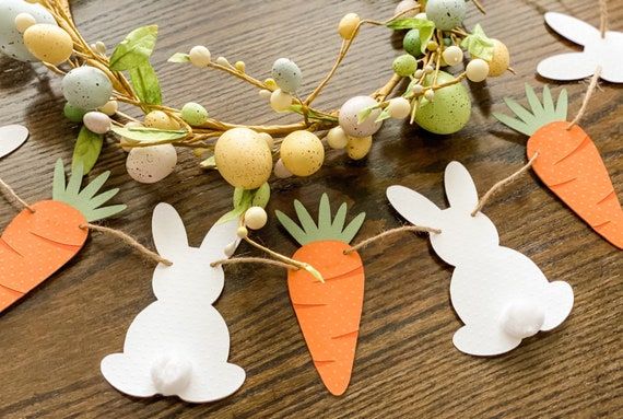 some paper carrots are hanging on a string