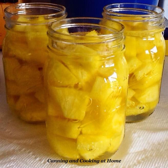 three jars filled with sliced pineapples sitting on a table