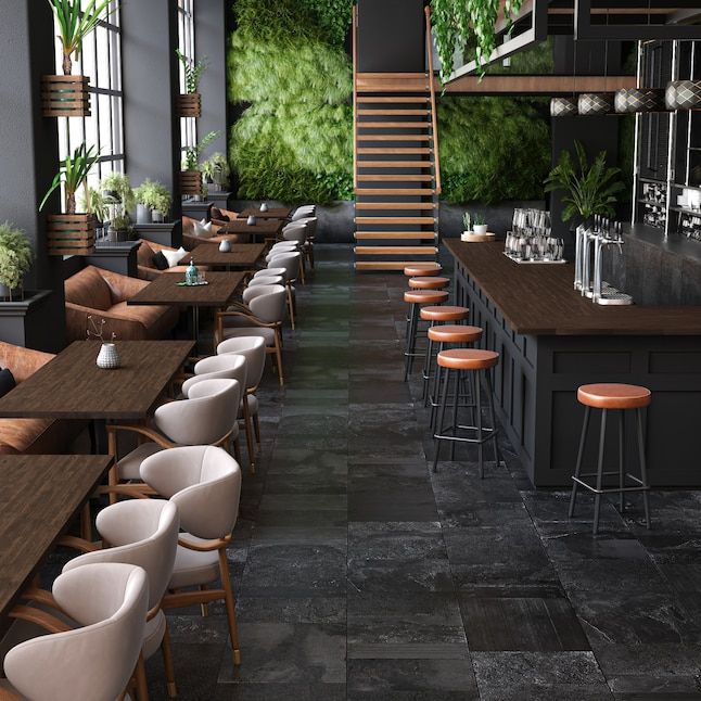 a restaurant with wooden tables and white chairs next to a staircase leading up to the second floor