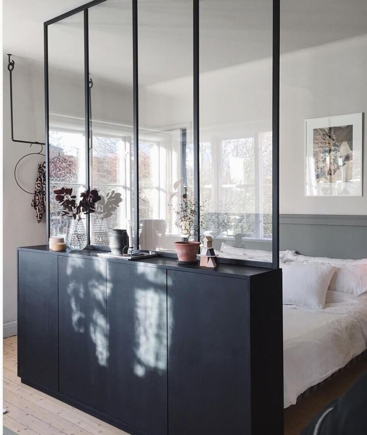 a bedroom with mirrors on the wall and furniture