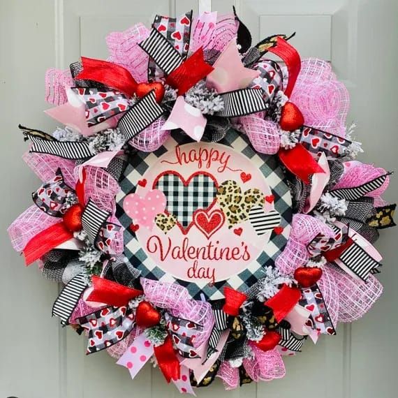 a valentine's day wreath hanging on the front door