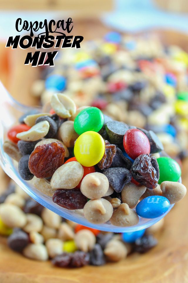 a spoon full of colorful candy beans on top of a wooden table with text overlay that reads copycat monster mix