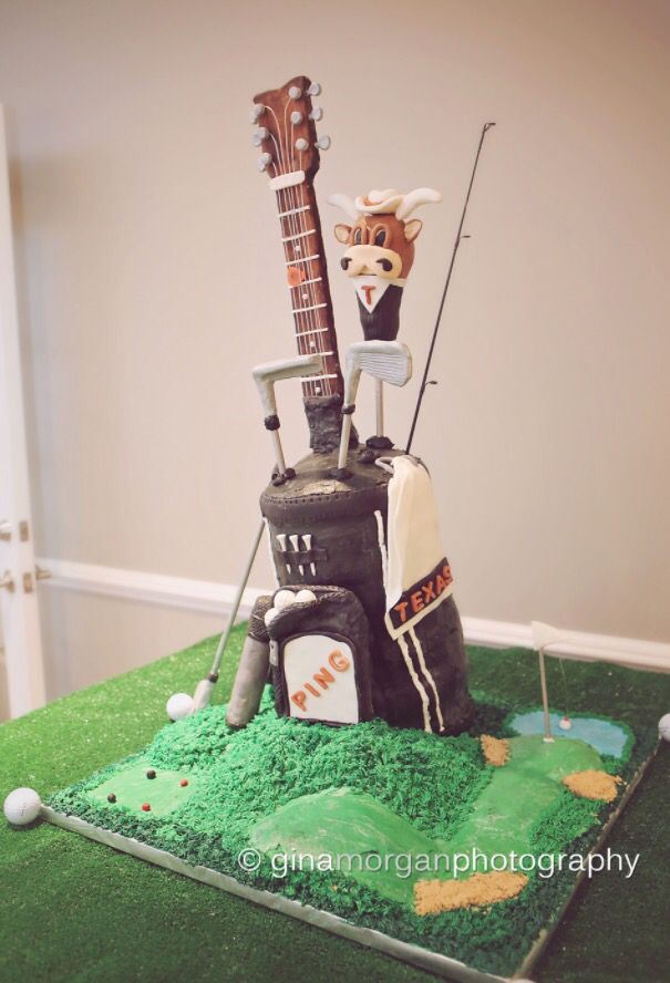 a cake made to look like a golf course with an animal on the top and a guitar in the middle