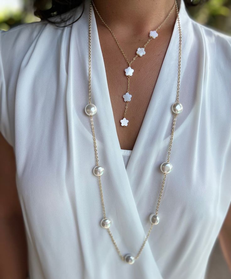 Add a touch of classic elegance to your look with the Kate Pearl Necklace. Six lustrous Mother of Pearls adorn this gorgeous 18k gold plated chain necklace. Can be worn alone or layered, either way you'll receive tons of compliments! 18k gold plating mother of pearl pendant length: 36" Elegant White Chain Necklace With Pearl Drop, Elegant Pearl Layered Necklace As Gift, Elegant Pearl Layered Necklace Gift, Elegant Layered Pearl Necklace As Gift, Luxury White Clavicle Chain Necklace, Elegant Pearl Layered Necklace With Delicate Chain, White Necklaces With Gold Chain For Formal Occasions, Formal White Necklaces With Gold Chain, White Gold Chain Necklace For Formal Occasions