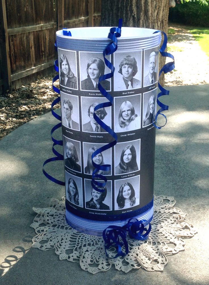 a blue ribbon wrapped around a bucket with pictures on it