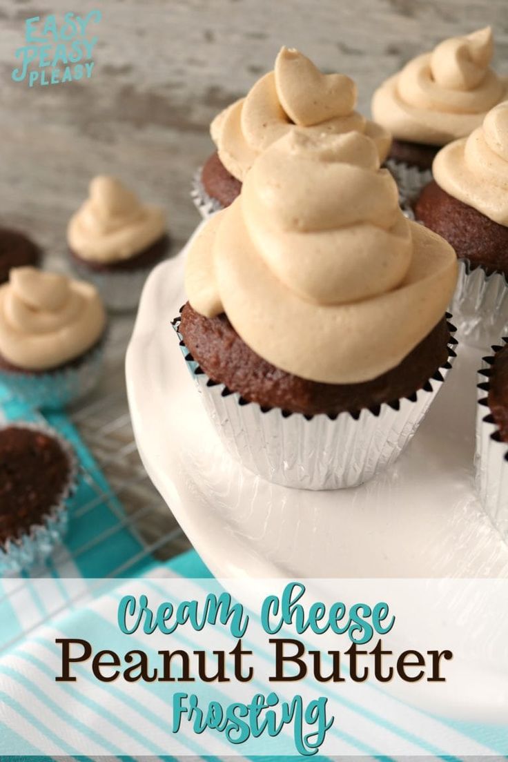 cupcakes with cream cheese frosting sitting on a plate