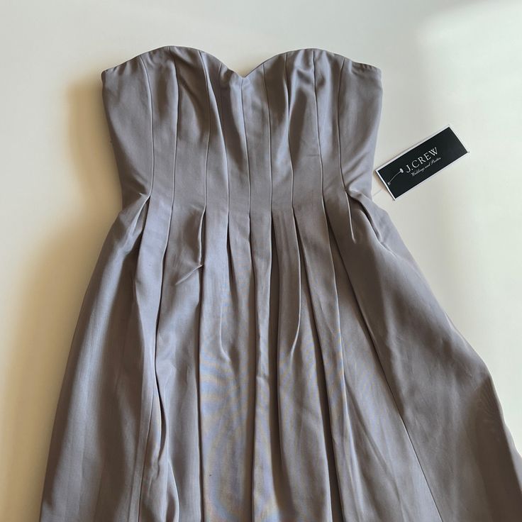 A Perfect Bridesmaid Dress, Or Use For Any Occasion! New With Tags- Purchased In 2016 For A Wedding, But Wore Something Else And It Has Been Sitting In A Closet Ever Since! In Great Condition. Colour Is A Nice Neutral Grey With Some Purple Ish Undertones. Pleated Wedding Dress With Sweetheart Neckline, Strapless Spring Dress For Formal Occasions, Strapless Dress For Spring Formal, Strapless Formal Dress For Spring, Strapless Pleated Wedding Dresses, Strapless Spring Formal Dress, Summer Formal Strapless Dress With Pleated Bodice, Lined Midi-length Wedding Dress, Lined Midi Length Wedding Dress