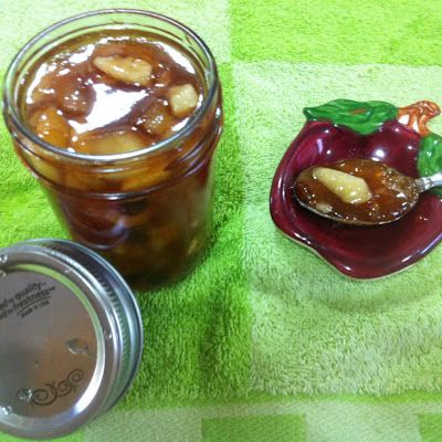 two jars filled with food sitting on top of a green towel