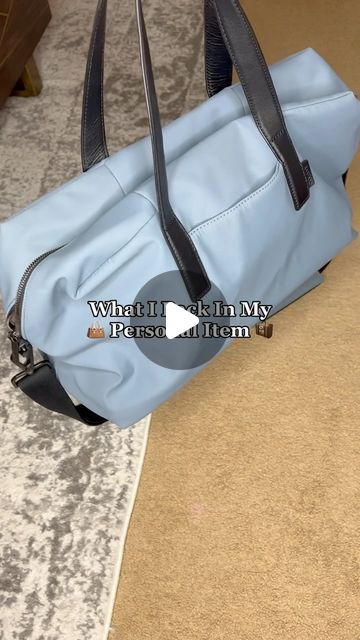 a blue purse sitting on top of a carpet