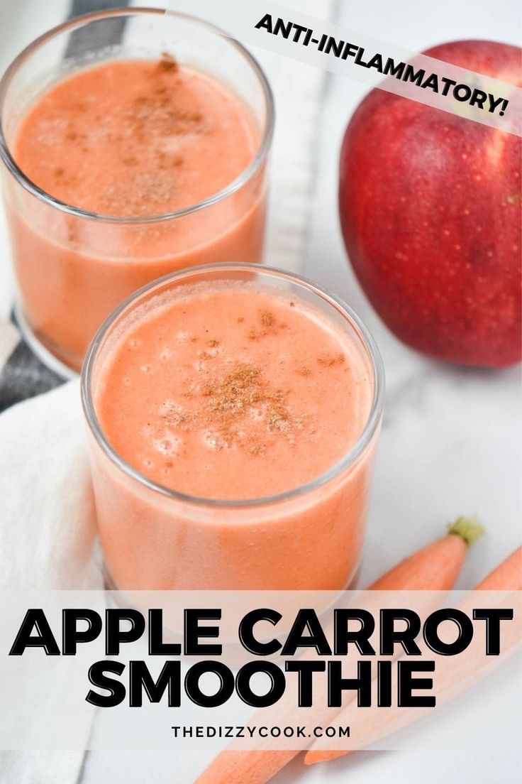 two glasses of apple carrot smoothie on a table with an apple in the background