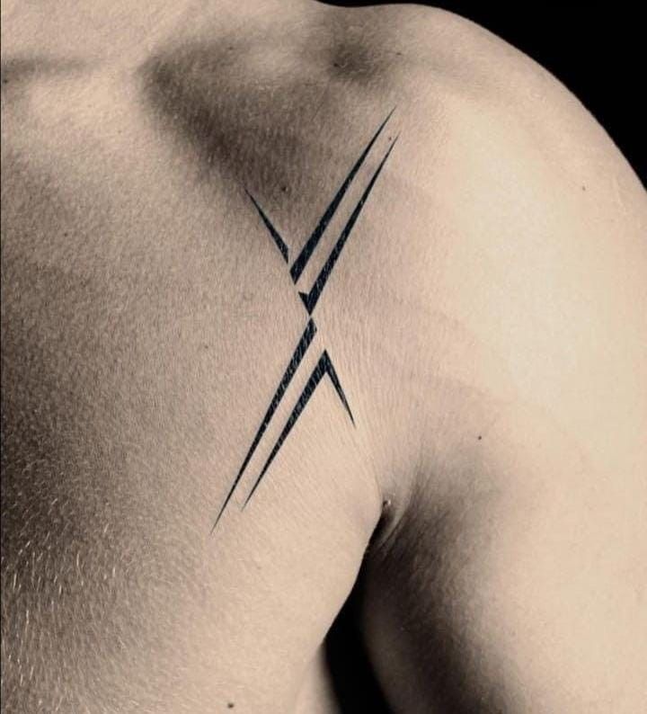 a black and white photo of a man's back with two crossed lines on it