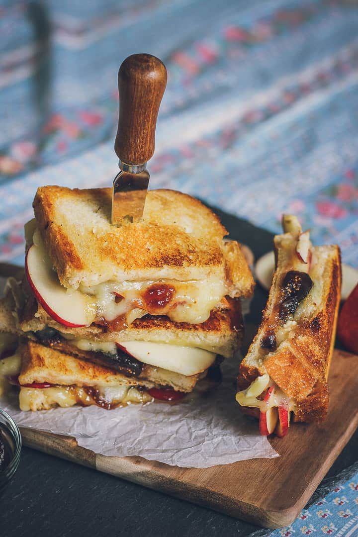 a grilled cheese sandwich cut in half on a cutting board