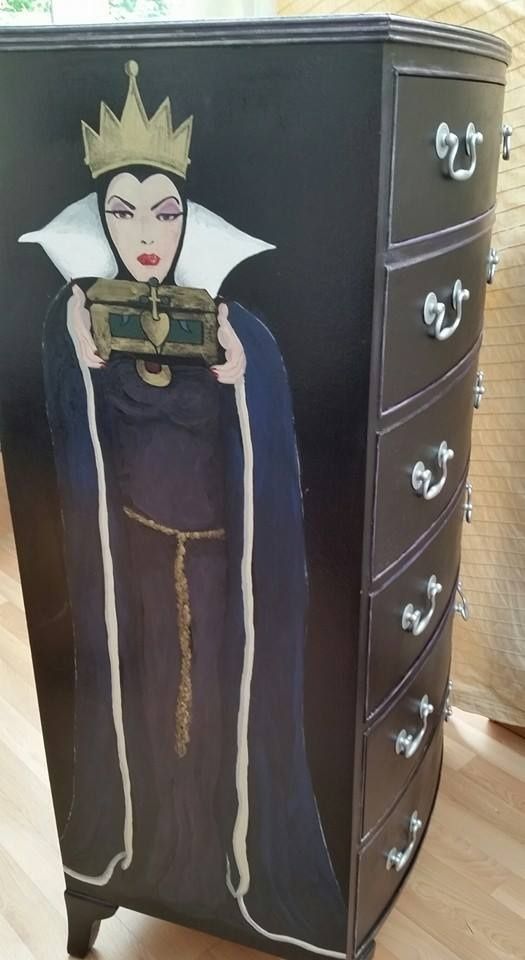 a painted dresser with a queen holding a camera