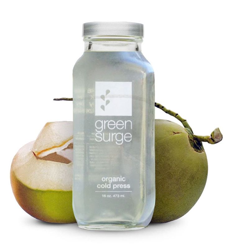 a bottle of green surge organic cold pressed water next to an apple and another fruit