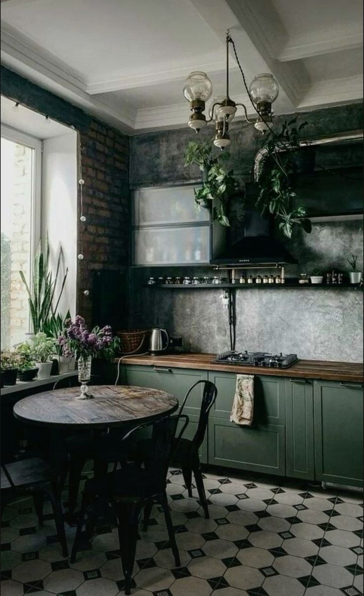 a kitchen with black and white checkered flooring, green cabinets and an old - fashioned table