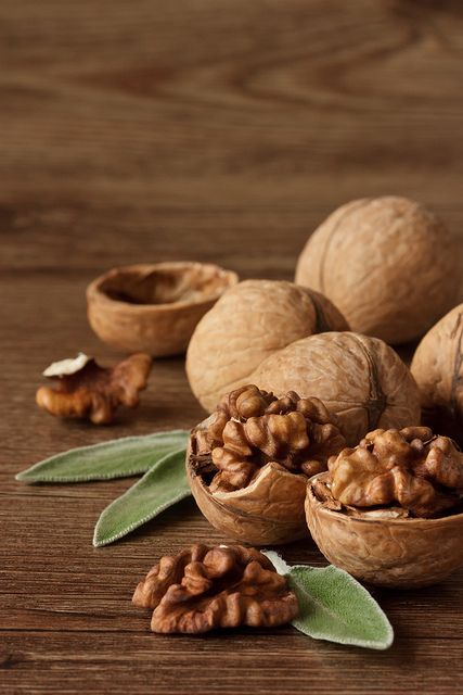 walnuts and leaves with the words benefits and uses of walnuts