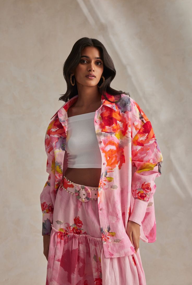 The Rosa Pink Oversized Shirt is an uplifting style from the Spring'24 Collection. Dipped in a blushing pink hue and overall floral print, it is crafted in lightweight and airy cotton linen. An oversized silhouette, the shirt features full cuffed sleeves, a smart shirt collar, and a front placket button closure which is beautifully accentuated with embroidered buttonholes. Take it for that poolside soiree paired with the Rosa Pants for a lovely Springtime look. Made In India Pink Abstract Floral Oversized Floral Print Summer Blouse, Oversized Summer Blouse With Floral Print, Spring Linen Blouse With Floral Print, Spring Floral Print Linen Tops, Spring Daywear Shirt With Relaxed Fit, Spring Linen Floral Print Tops, Spring Daywear Blouse With Spread Collar, Oversized Blouse For Spring Daywear, Oversized Spring Blouse For Daywear