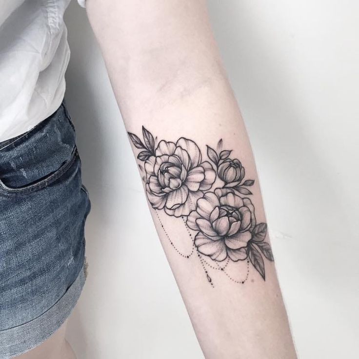 a woman's arm with flowers on it