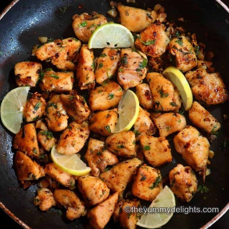 chicken with lemons and herbs in a skillet