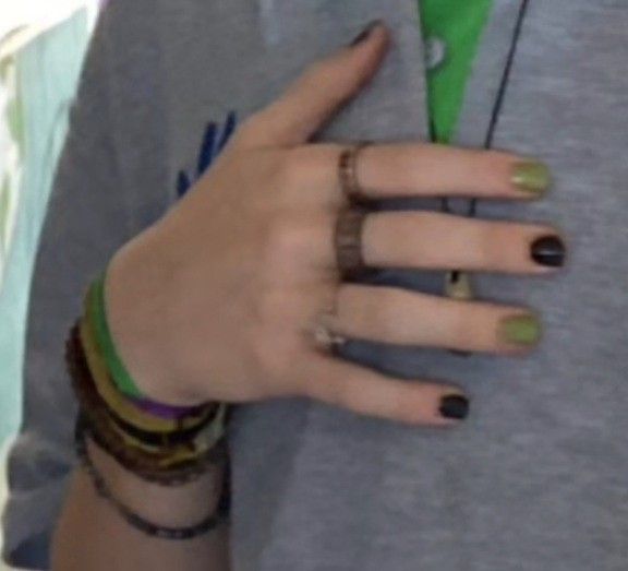 a person with two rings on their fingers and some bracelets around their wrist,