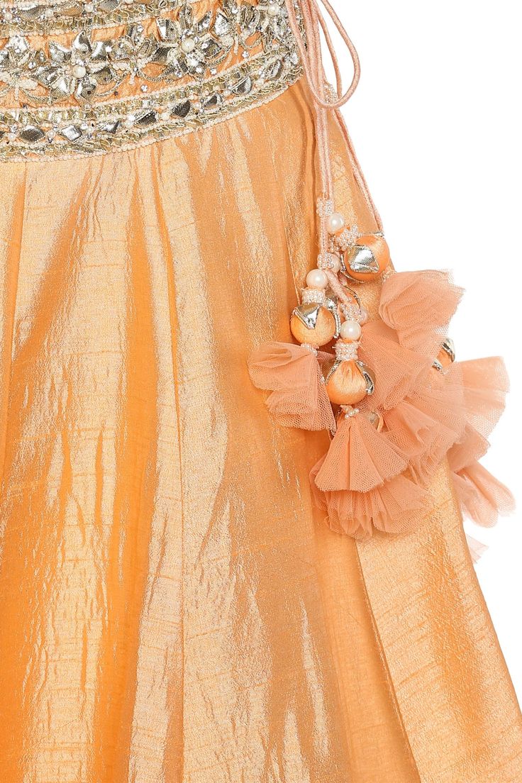 A winning style this wedding season is this opulent peach lehenga set. Boasts of a tie-up back blouse and enhanced with glistening gota patti and pearl embellishments, this vibrant beauty is coordinated with a matching dupatta. 
comes with dupatta
gota patti work
pearl embellished
tie up back blouse - Aza Fashions Elegant Peach Lehenga For Eid, Peach Dress With Zari Work In Traditional Drape, Peach Traditional Drape Dress With Zari Work, Elegant Peach Sharara For Diwali, Peach Saree Set With Zari Work, Peach Dupatta With Zari Work For Reception, Reception Peach Dupatta With Zari Work, Peach Traditional Wear With Dupatta For Reception, Peach Traditional Wear For Reception