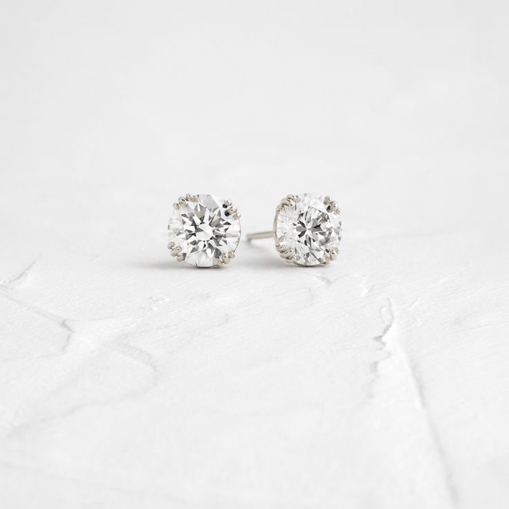 A pair of matching round brilliant cut diamonds in your choice of natural or lab-grown diamond. Please note: these earrings are listed with the total carat weight for both studs together. Each diamond is SI+ clarity, G+ color. Solid 14k gold posts and butterfly backings. Also available in platinum. Sold as a pair. We handcraft each piece with responsibly sourced metals and ethically sourced stones. Minimalist Round Cut Diamond Earrings With Accents, Timeless Cubic Zirconia Diamond Earrings With Prong Setting, Minimalist Solitaire Diamond Earrings, Round Diamond Earrings With Accents For Everyday, Minimalist Solitaire Cubic Zirconia Diamond Earrings, Minimalist Cubic Zirconia Solitaire Diamond Earrings, Minimalist Brilliant Cut Round Diamond Earrings, Everyday Round Diamond Earrings With Accents, Minimalist Round Cut Brilliant Diamond Earrings