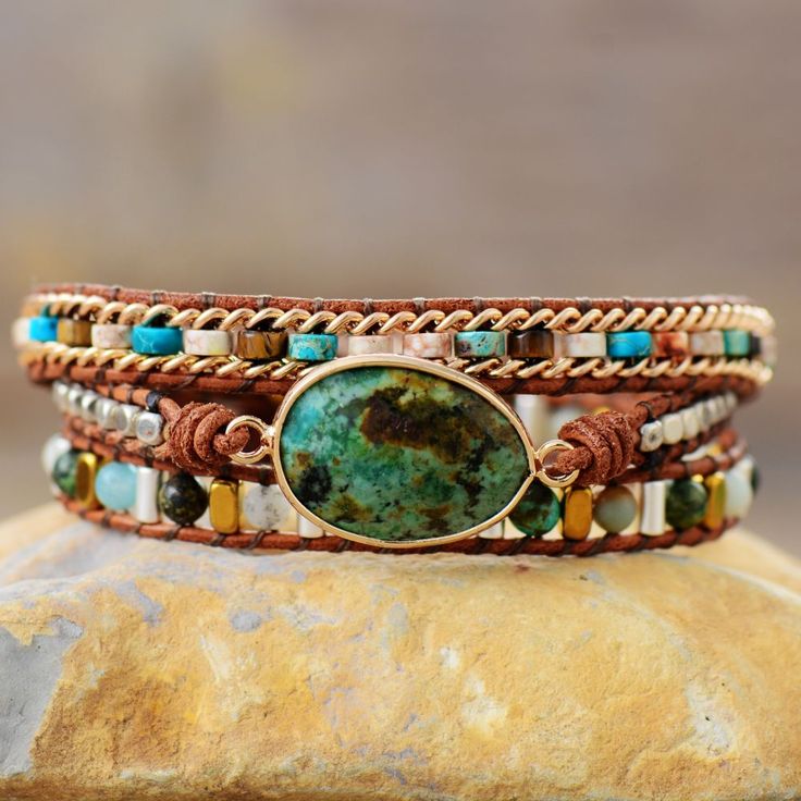 Wear the Nature Jasper Goddess Bracelet to feel inspired! This stunning wrap bracelet was handcrafted with original designs that will make you feel closer to nature. Enjoy the beautiful picturesque design and be enthralled by its natural charm. Embrace your inner goddess and unlock your inner power with this gorgeous bracelet! Middle Stone: Amazonite/African Turquoise Material: African Turquoise, Amazonite, Jade, Agate, Jasper, Crystal, Leather Size: 50cm, 3 closures adjust length to fit your wr Bohemian Adjustable Wrap Bracelet With Gemstone Beads, Spiritual Adjustable Hand Wrapped Bracelet, Handmade Adjustable Spiritual Wrap Bracelet, Hand Wrapped Turquoise Spiritual Wrap Bracelet, Earthy Adjustable Hand Wrapped Bracelet, Adjustable Earthy Hand Wrapped Bracelet, Adjustable Turquoise Bracelets With Nature-inspired Style, Earthy Hand Wrapped Bracelets For Festival, Bohemian Adjustable Wrap Bracelet For Healing