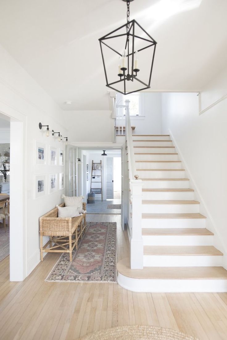 the stairs in this house are made of wood and have white painted trimmings