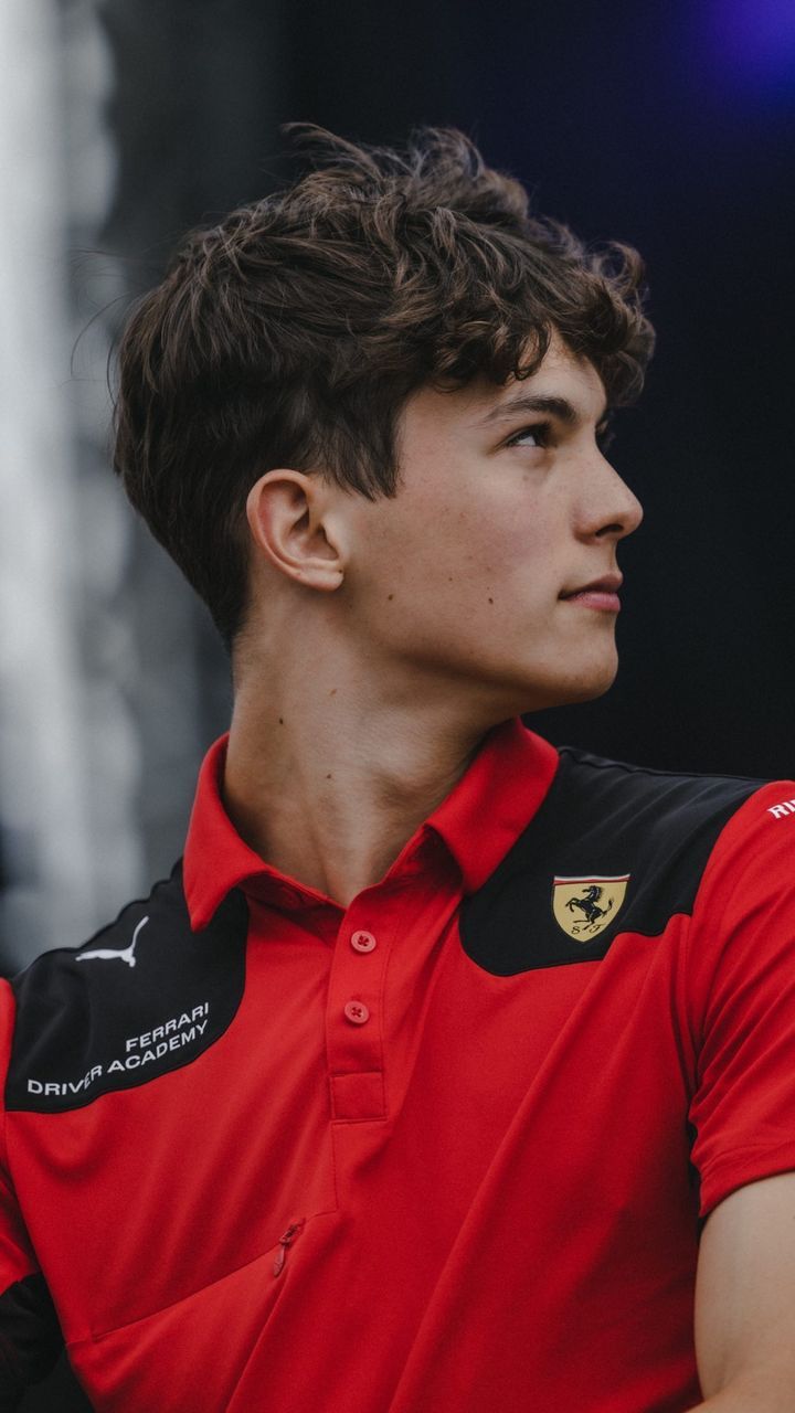 a young man wearing a red polo shirt