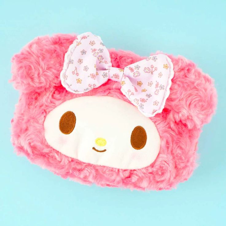 a pink stuffed animal with a bow on it's head