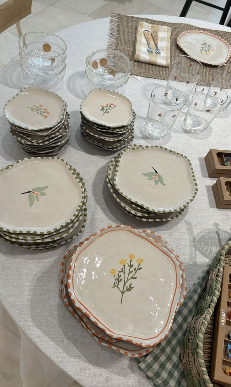 a table topped with lots of plates and bowls