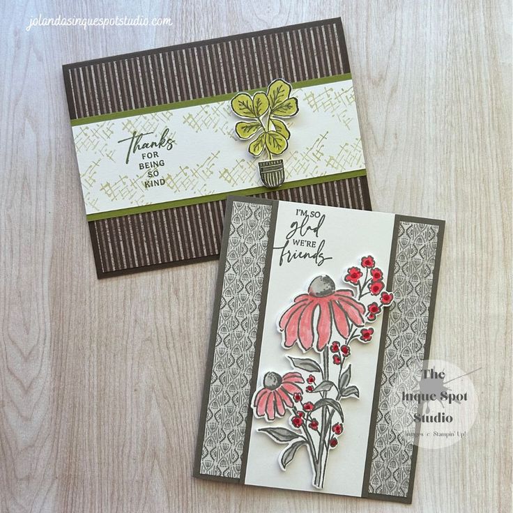 two cards with flowers on them sitting next to each other