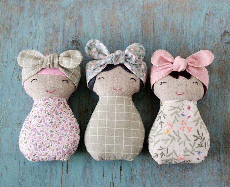 three small stuffed animals with bows on their heads