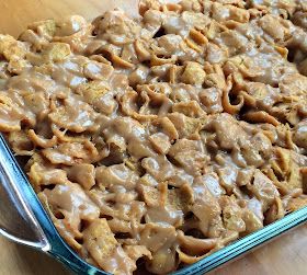 a casserole dish filled with meat and gravy on a wooden table