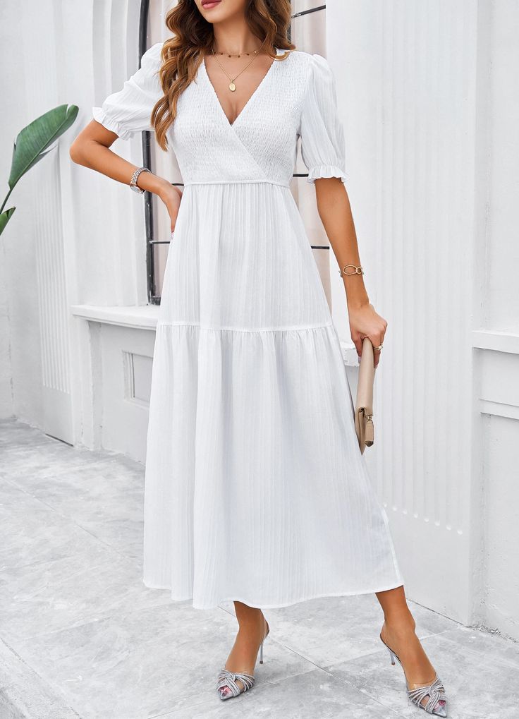 Introducing the Meadow Smock Midi Dress - a playful choice for your summer wardrobe. This bridal white dress features a smock design, perfect for lazy days or dress-up occasions. Bring a touch of quirkiness to your style with this unique and comfortable piece. (Limited stock, so act fast!) Size Guide: Model is 5’7” tall, and has a 33.8” bust, 24.2” waist, & 35.5” hips. She is wearing a S / US 4 / AU 8. This dress is true to size. Material: 96% Polyester 4% Elastane Feature: V Neckline. Short Sleeves. Smocked Body. Tiered Style. Side Slit. Midi length. Relaxed fit. Care Instructions: Machine wash / Cold hand wash White Bridal Dresses, Reindeer Headband, Brown Leather Sandals, Daily Dress, Dress Jewelry, White Midi Dress, Midi Length, Summer Wardrobe, Smocking